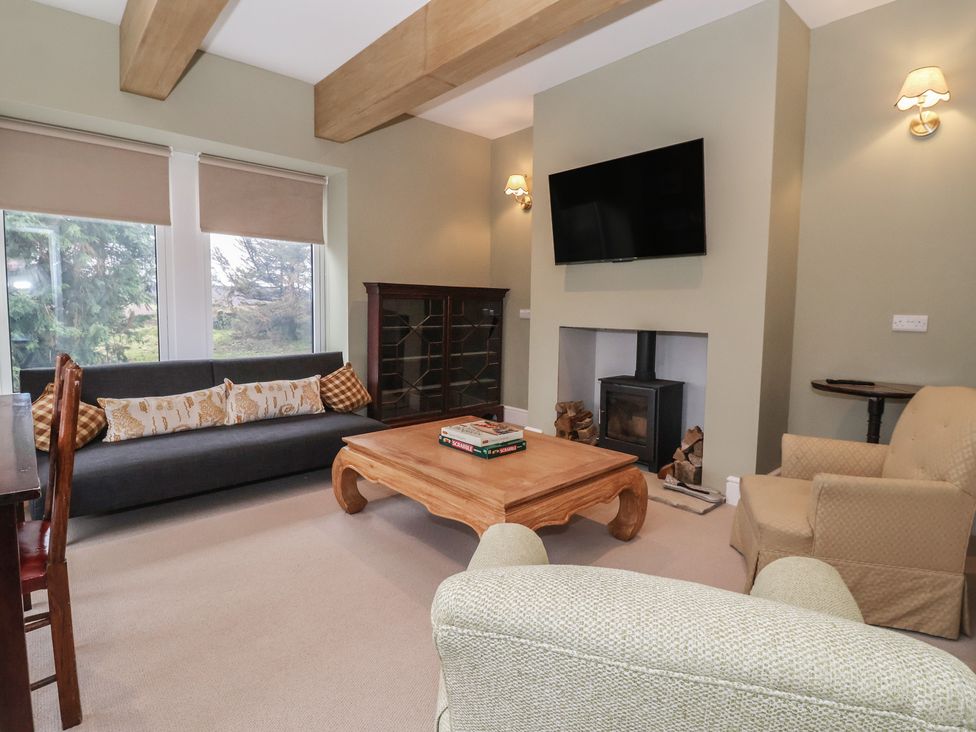 A living room with a sofa and coffee table at Daisy Mount in Keighley