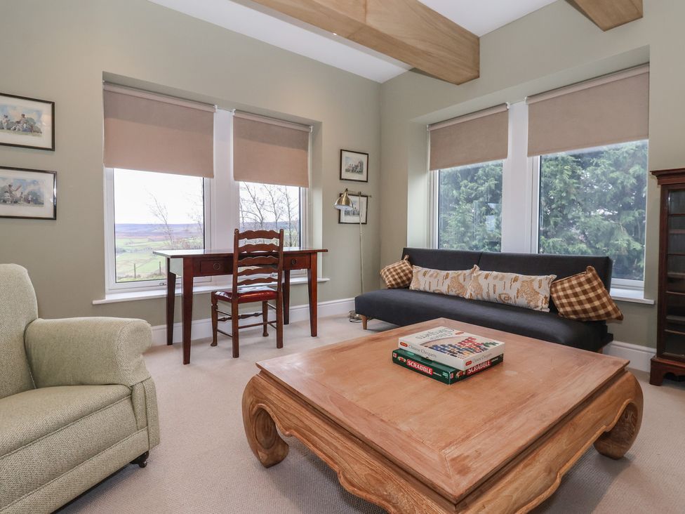 A living room with a sofa and coffee table at Daisy Mount in Keighley