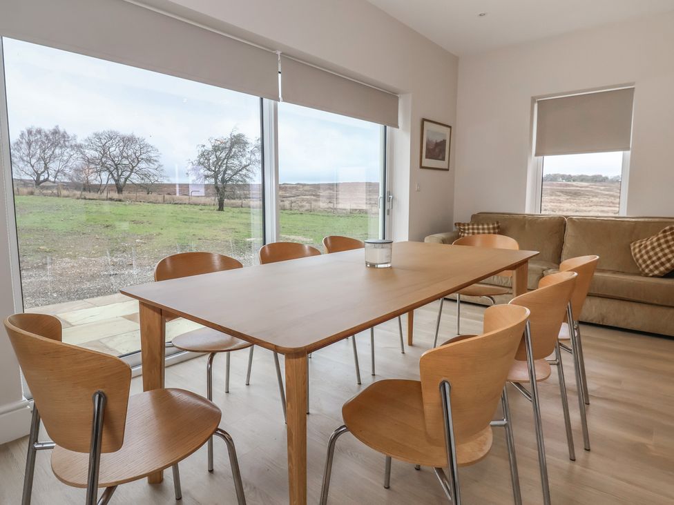 A dining room with a table and chairs at Daisy Mount in Keighley