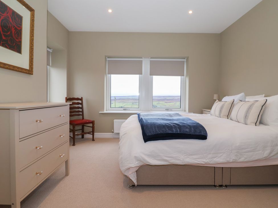 A bedroom with a bed and a window view at Daisy Mount in Keighley