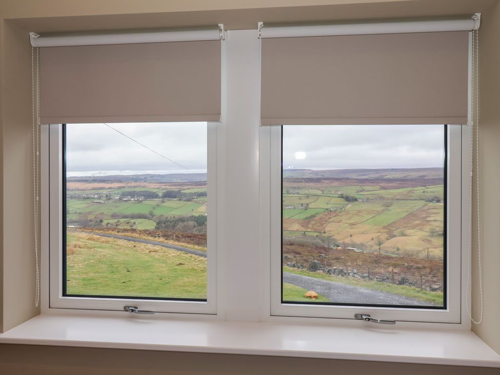 A view from a window with a roller blind at Daisy Mount in Keighley