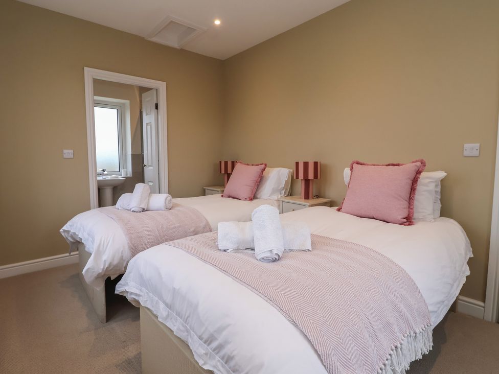 A bedroom with two beds and pillows at Daisy Mount in Keighley