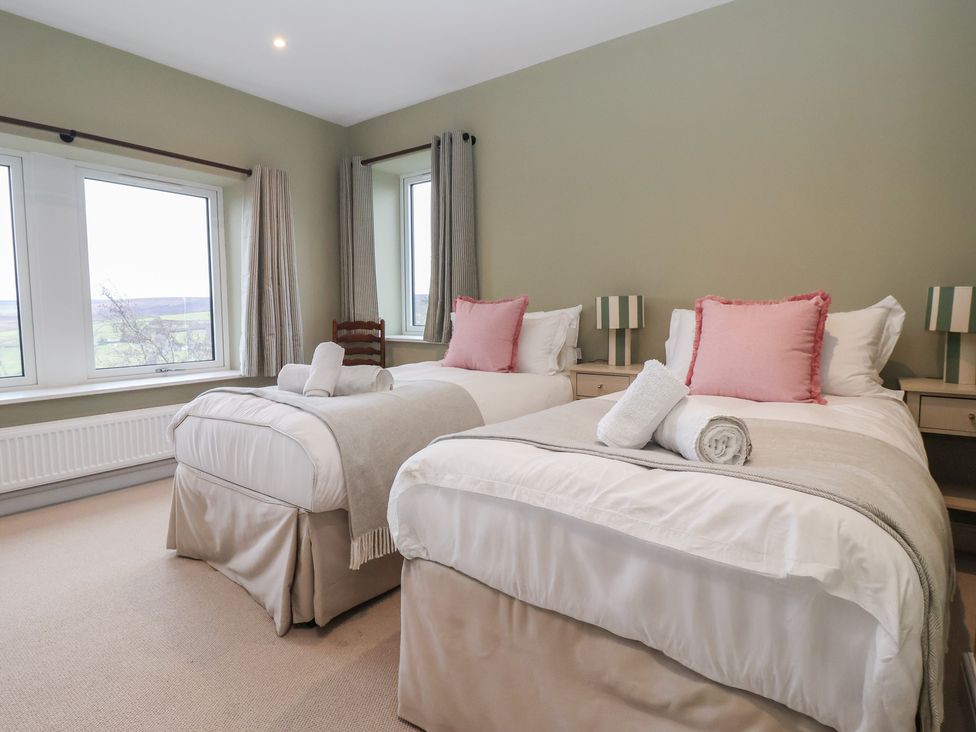 A bedroom with two beds at Daisy Mount in Keighley
