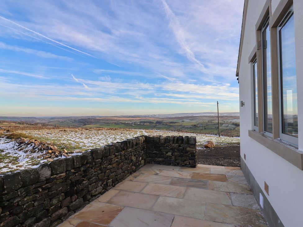 An outdoor view with a stone wall and landscape at Daisy Mount in Keighley