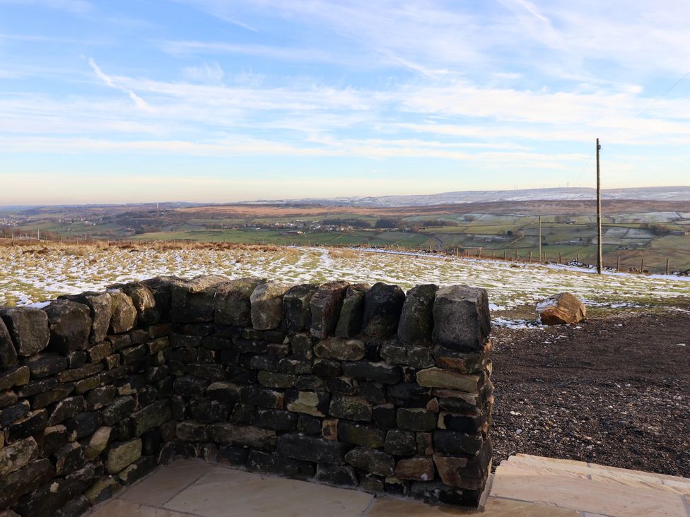 A view of a landscape with a stone wall at Daisy Mount in Keighley