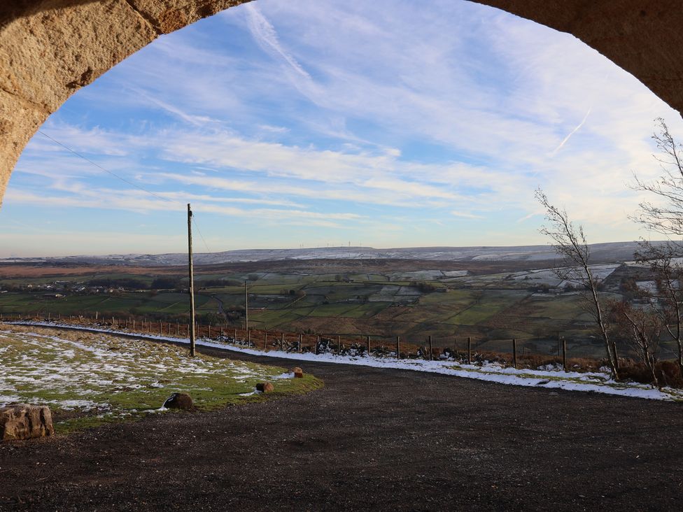 A view of fields and hills from an archway at Daisy Mount in Keighley