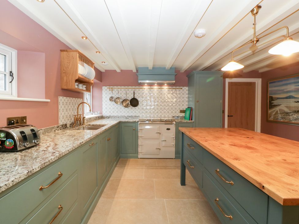 A kitchen with a countertop and kitchen island at Velindra Farm Cottage Hereford