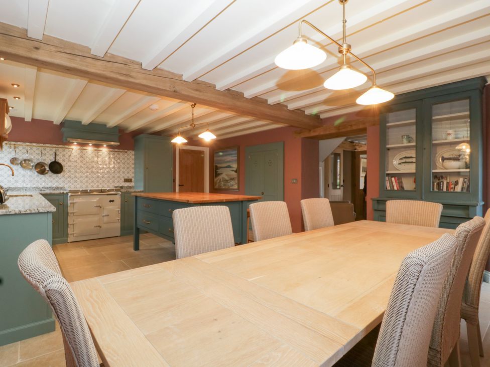 A kitchen with a dining table and chairs at Velindra Farm Cottage in Hereford
