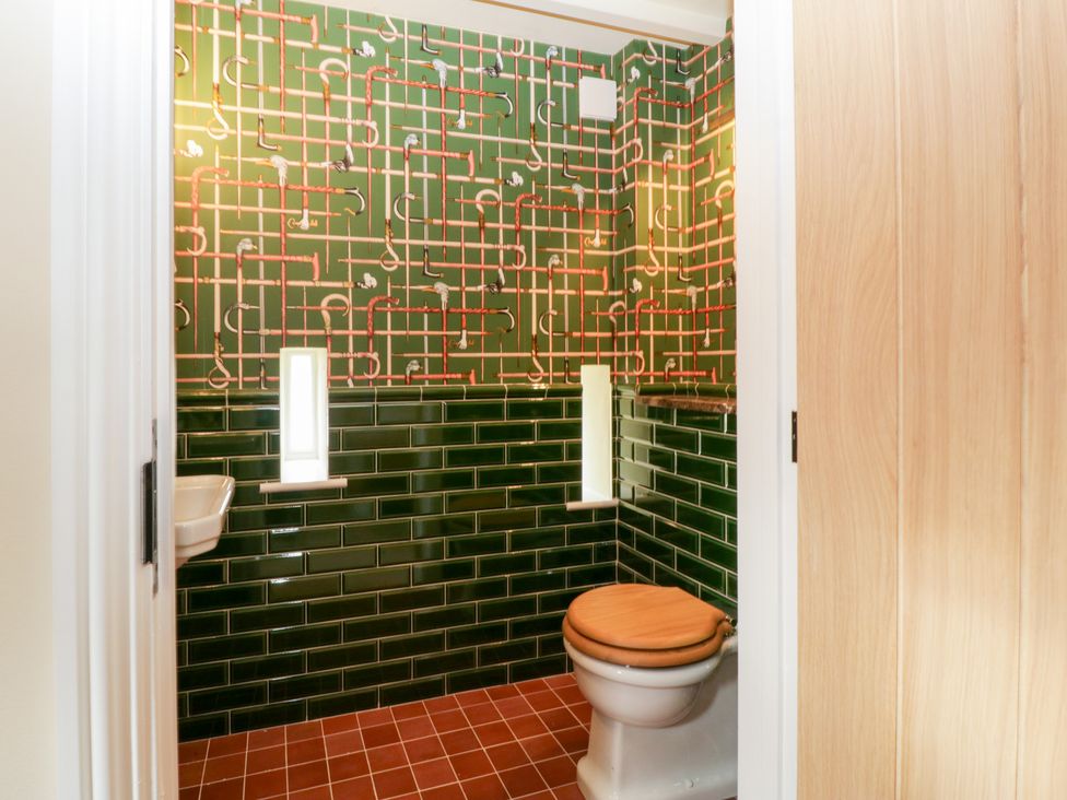 A bathroom with a toilet and sink at Velindra Farm Cottage Hereford