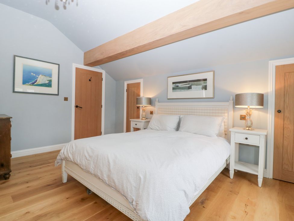 A bedroom with a bed and bedside tables at Velindra Farm Cottage Hereford