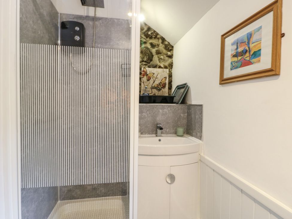 A bathroom with shower and sink at Fullers Studio in Caergeiliog