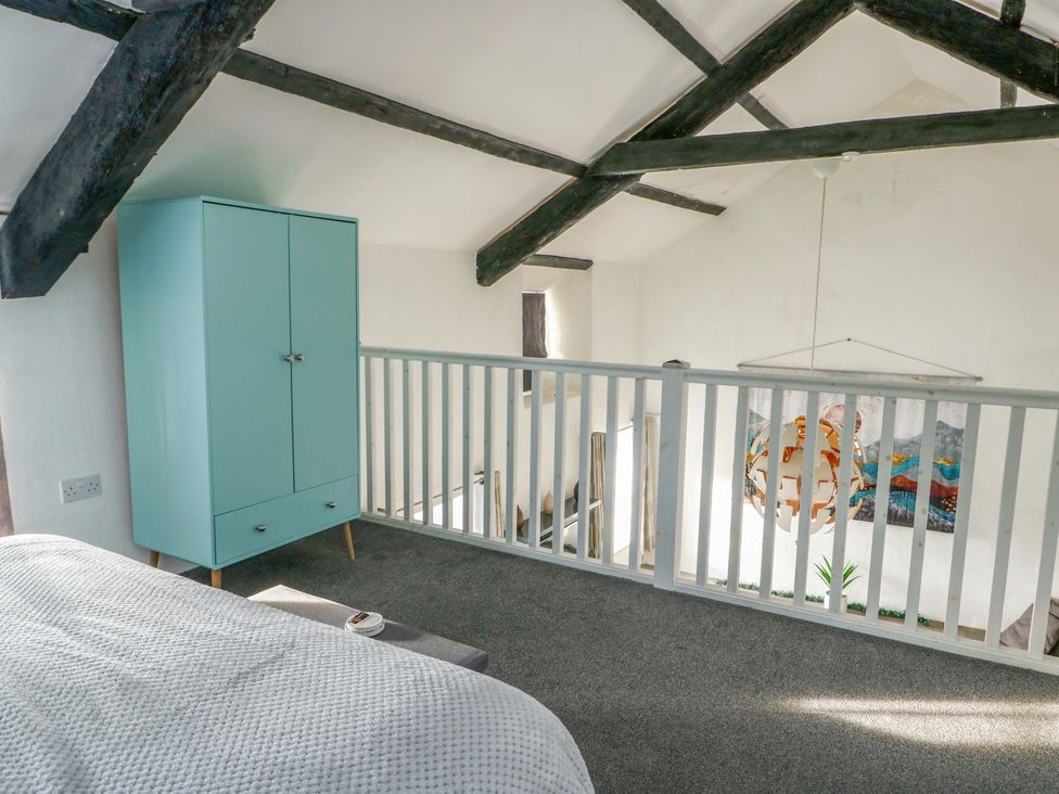 A bedroom with a wardrobe and railing at The Mill in Holyhead