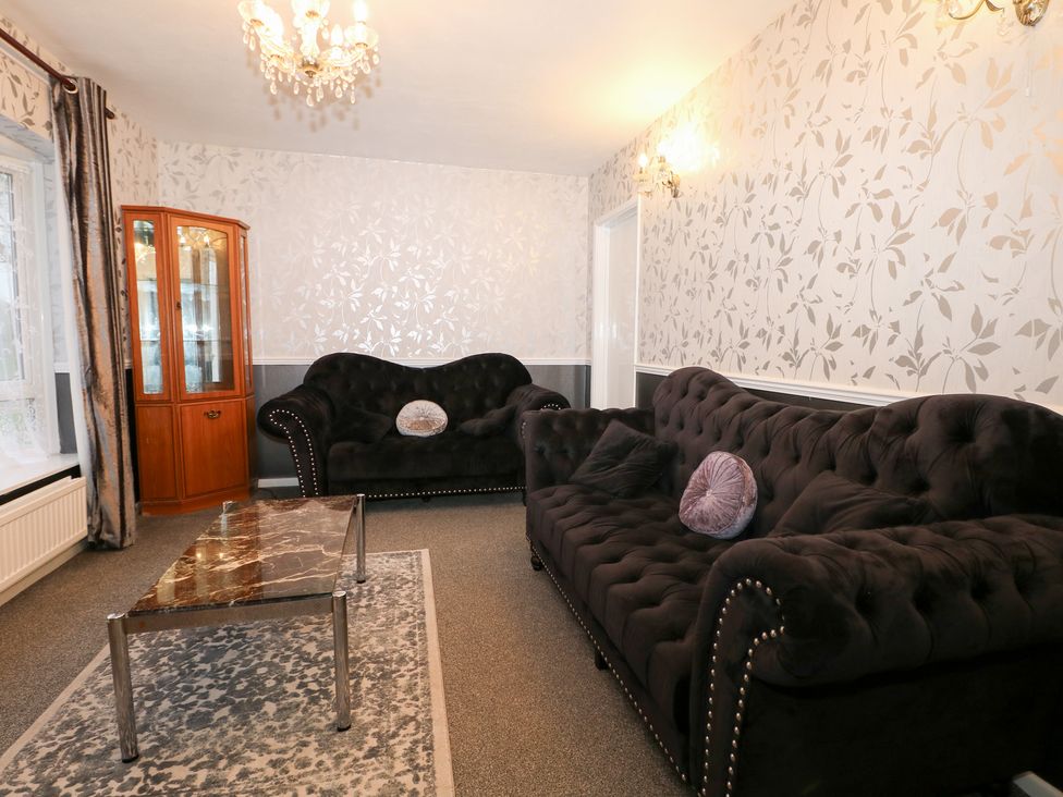 A living room with a sofa, coffee table, and cabinet at 24 Dunkirk Close in Romney Marsh