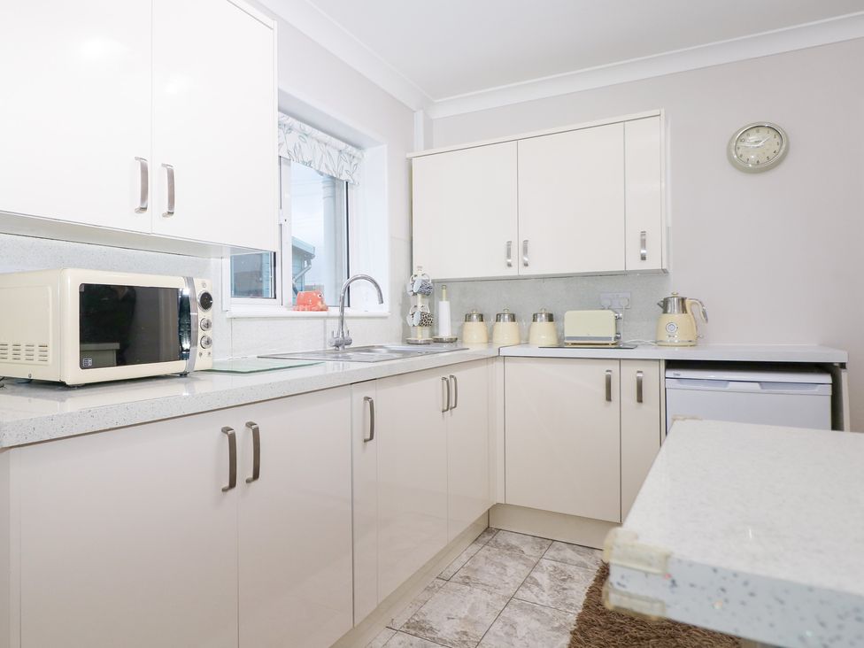 A kitchen with a microwave, sink, kettle and toaster at 24 Dunkirk Close, Romney Marsh