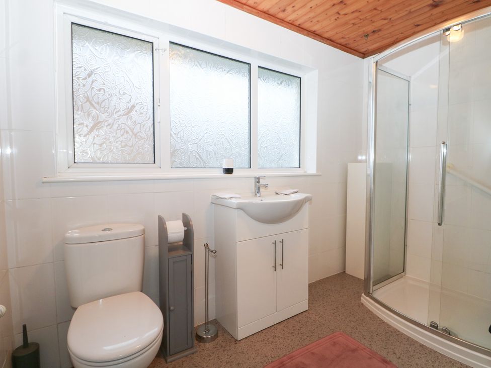 A bathroom with a toilet, sink, and shower at 24 Dunkirk Close Romney Marsh