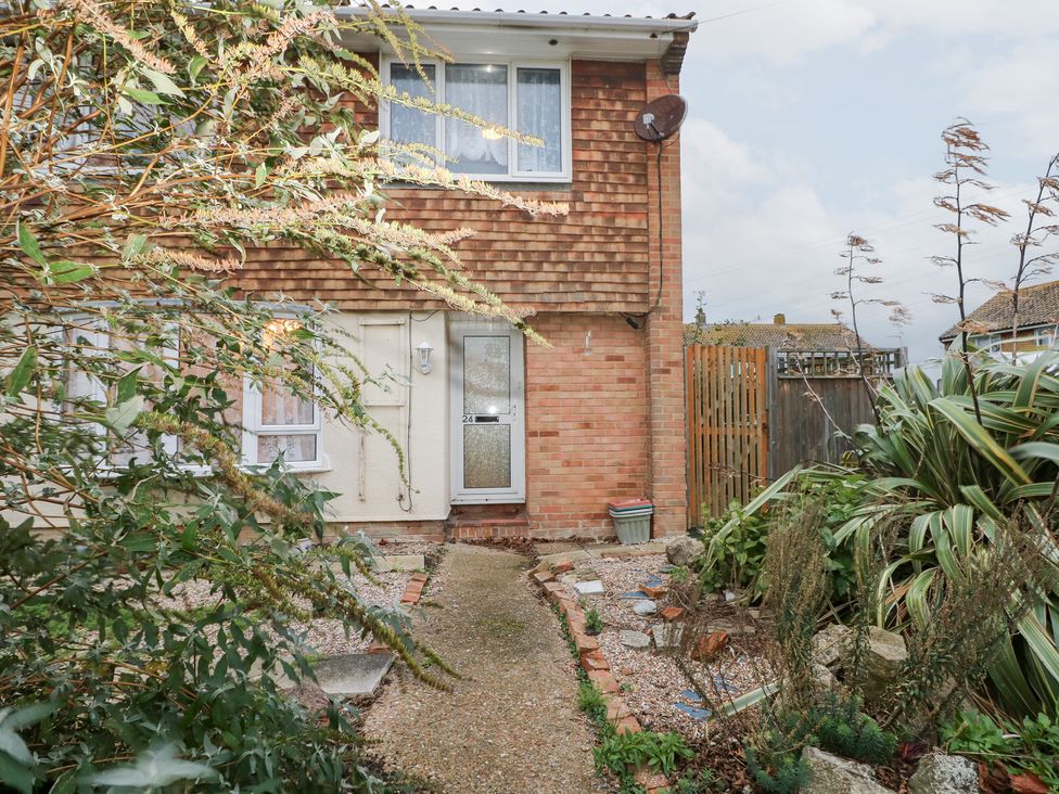 A front entrance with a door and garden features at 24 Dunkirk Close in Romney Marsh