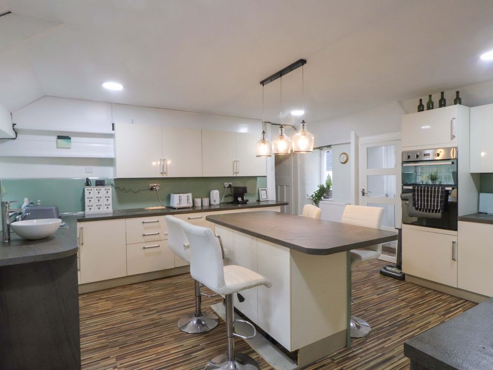 A kitchen with an island and appliances at Ty Crigyll in Holyhead