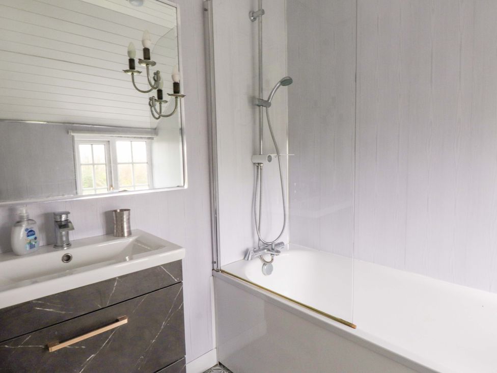 A bathroom with a bathtub and a sink at Ty Crigyll in Holyhead