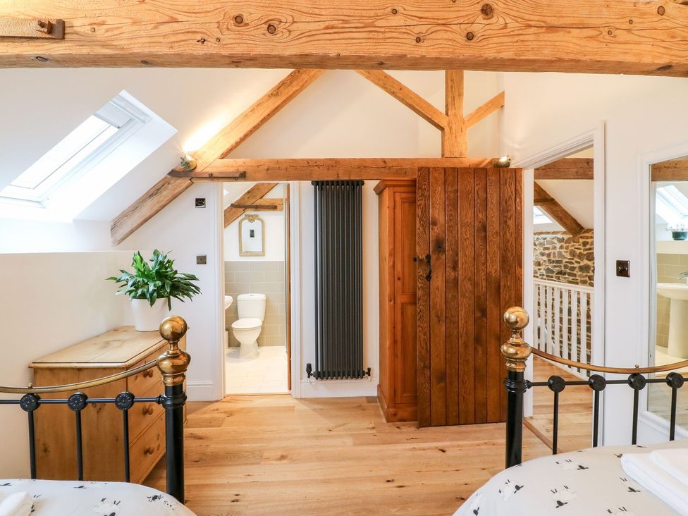 A bedroom with a bed and wardrobe at Lake View in Crediton