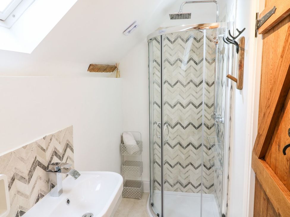 A bathroom with a shower and bathtub at Lake View in Crediton