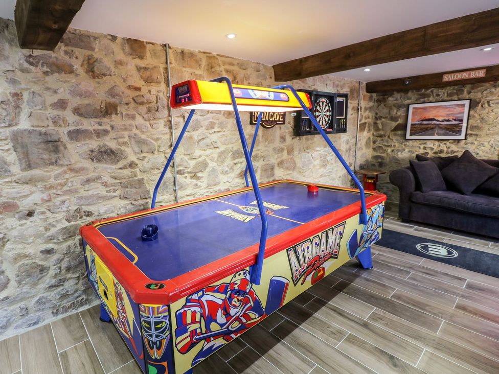 A game room with an air hockey table and dartboard at Lake View in Crediton