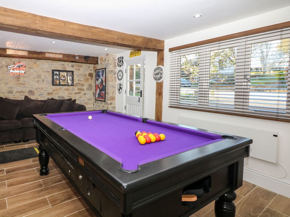 A game room with a pool table and a sofa at Lake View in Crediton