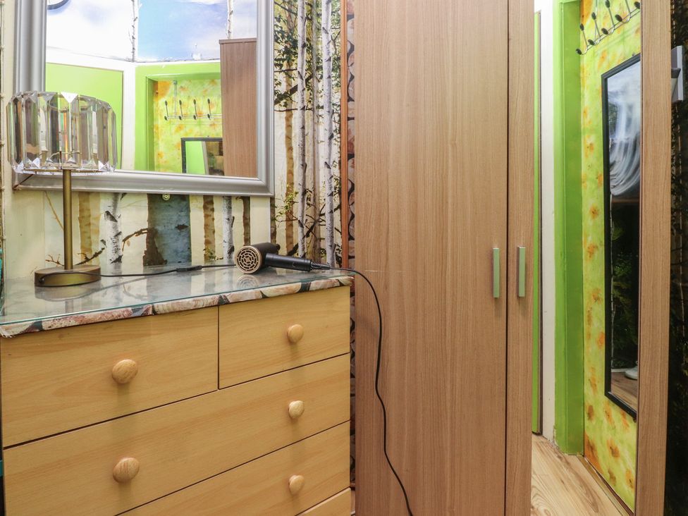 A bathroom with a mirror and dresser at Number 1 in Blackpool