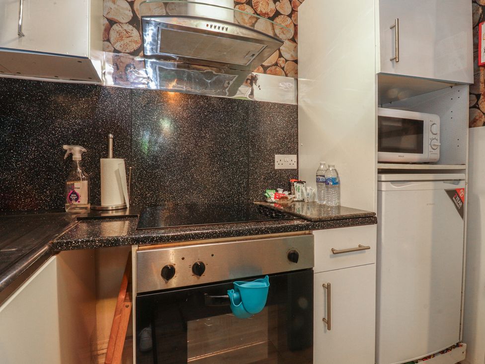 A kitchen with oven and refrigerator at Number 1 in Blackpool