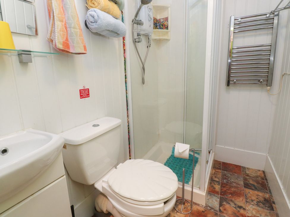 A bathroom with a sink, toilet, and shower at Number 1 in Blackpool