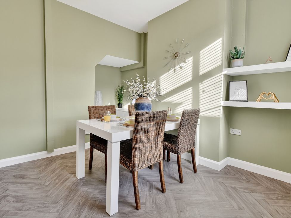 A dining room with a table and chairs at Windsor House in York