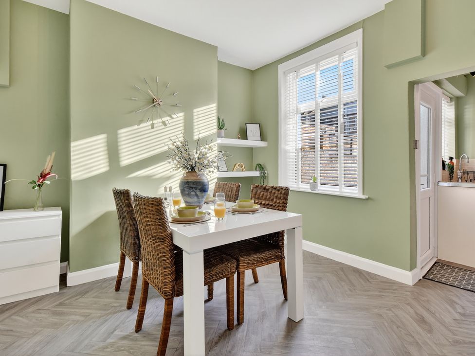 A dining room with a table and chairs at Windsor House in York