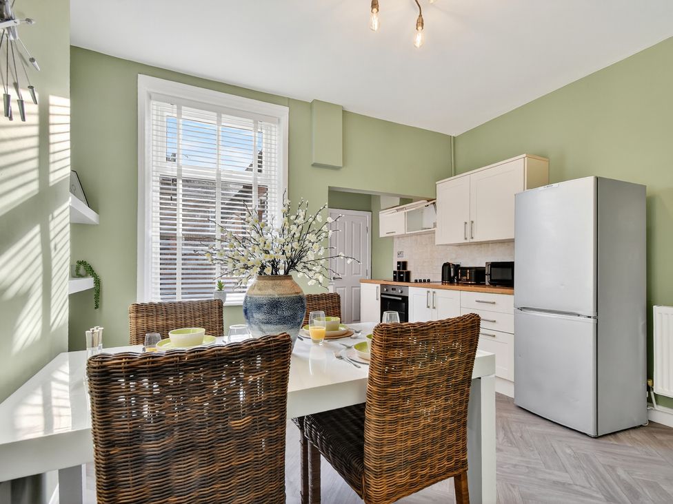 A kitchen with a dining table and chairs at Windsor House in York