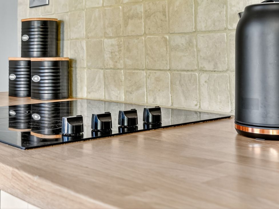 A kitchen with a cooktop and a kettle at Windsor House in York