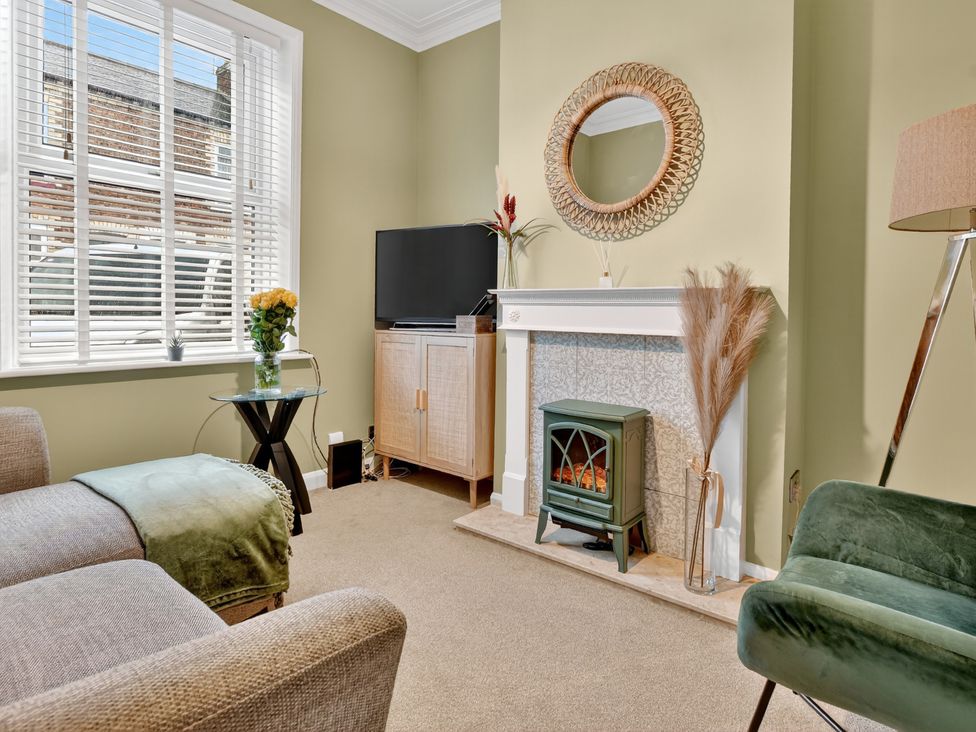 A living room with a television and fireplace at Windsor House in York