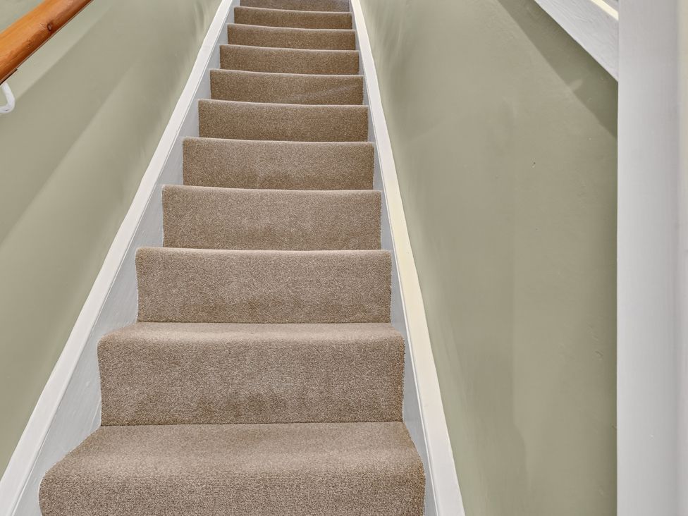 A staircase with carpet and a handrail at Windsor House in York