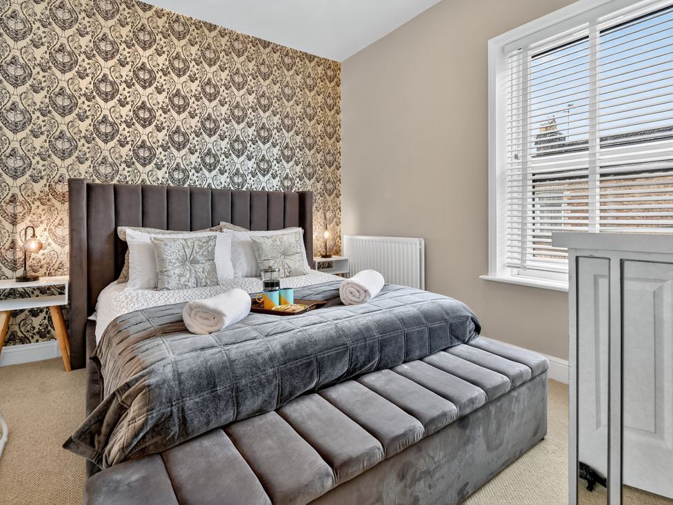 A bedroom with a bed and bedside tables at Windsor House in York