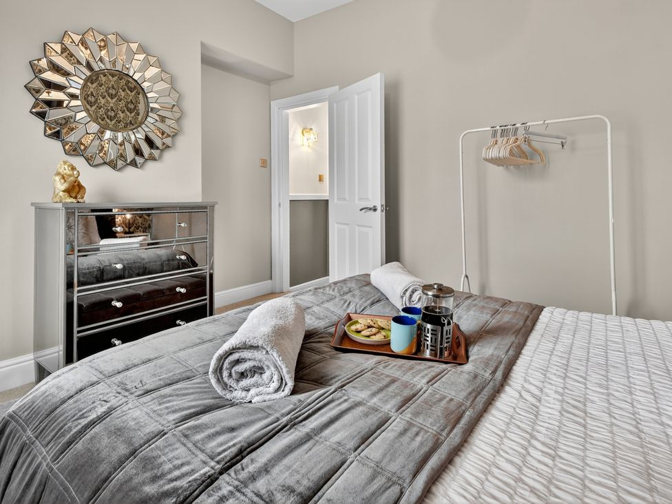 A bedroom with a bed and a dresser at Windsor House in York