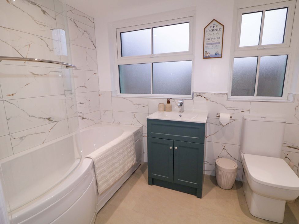 A bathroom with a bathtub and shower at Annie’s Farm Cottage