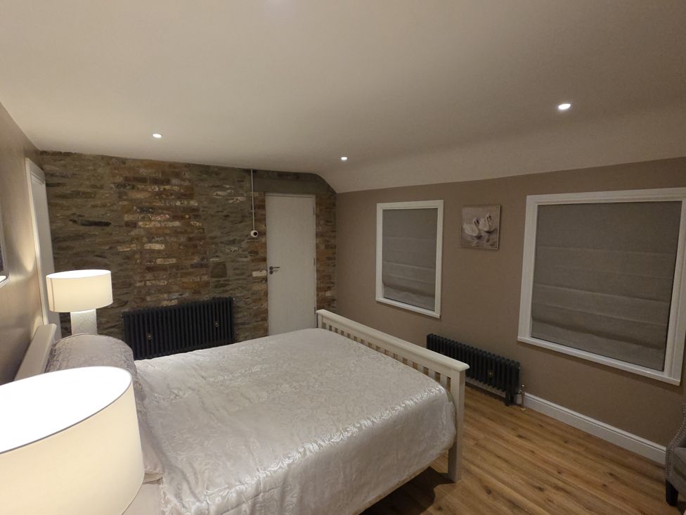 A bedroom with a bed and lamp at Annie’s Farm Cottage Near Londonderry, Northern Ireland