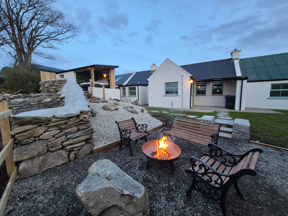 An outdoor area with a fire pit and benches at Annie’s Farm Cottage near Londonderry, Northern Ireland