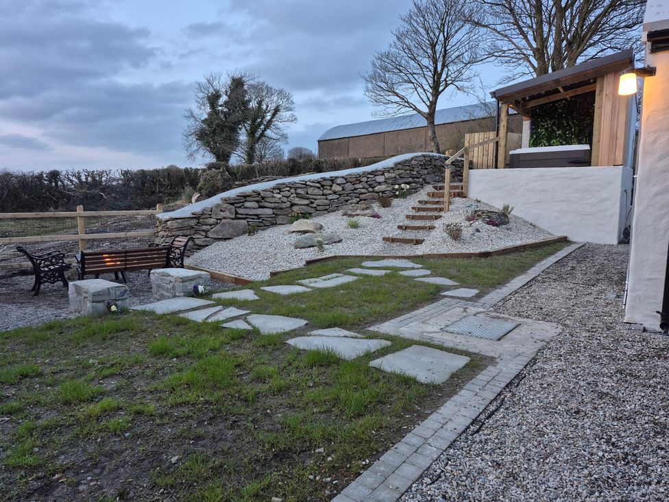 A garden with stone steps and benches at Annie’s Farm Cottage near Londonderry Northern Ireland