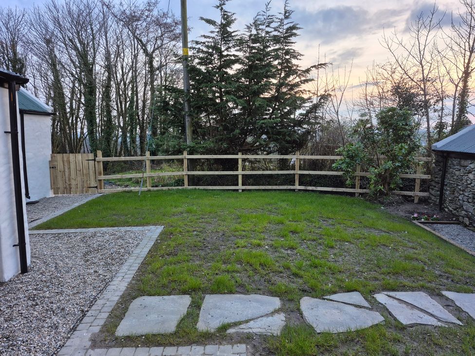 A garden with grass and a wooden fence at Annie’s Farm Cottage Near Londonderry, Northern Ireland