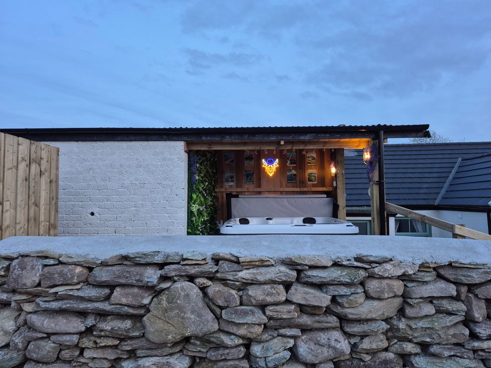An outdoor area with a hot tub and wooden shed at Annie’s Farm Cottage near Londonderry, Northern Ireland