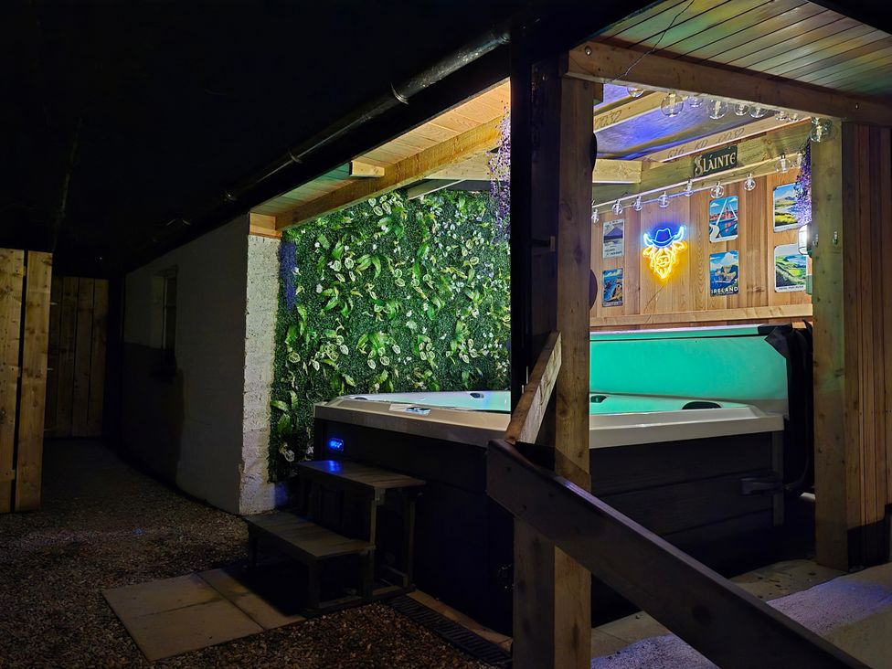 An outdoor area with a hot tub and decorative wall at Annie's Farm Cottage Near Londonderry, Northern Ireland