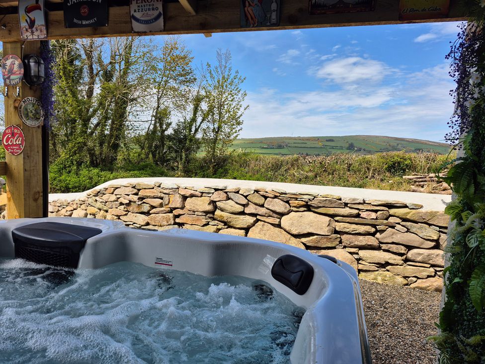 An outdoor area with a hot tub and a view of the landscape at Annie’s Farm Cottage Near Londonderry, Northern Ireland