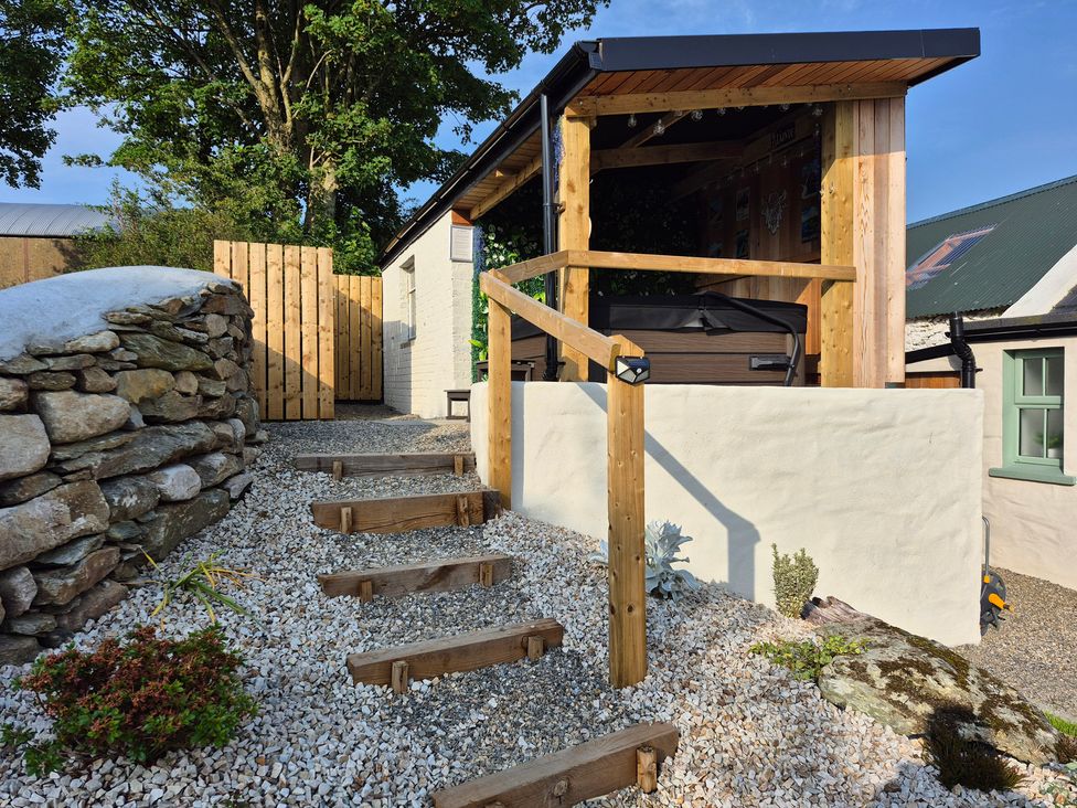 An outdoor area with a hot tub and wooden steps at Annie’s Farm Cottage near Londonderry, Northern Ireland
