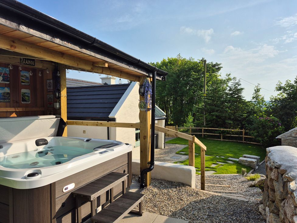 A hot tub with steps and a garden area at Annie’s Farm Cottage Near Londonderry, Northern Ireland