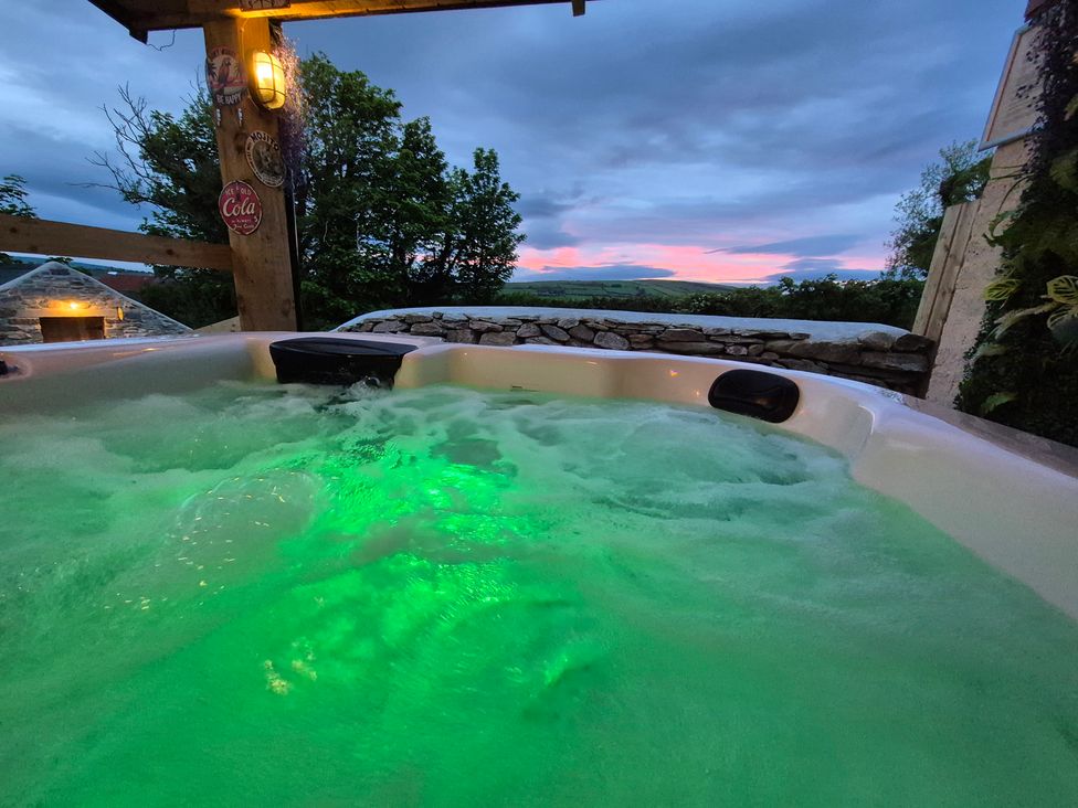 A hot tub with water and green light at Annie’s Farm Cottage Near Londonderry, Northern Ireland