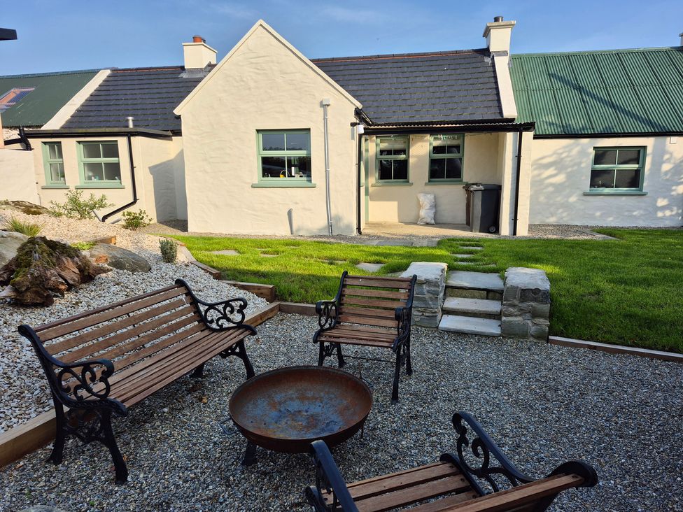 An outdoor area with chairs and a fire pit at Annie’s Farm Cottage near Londonderry, Northern Ireland