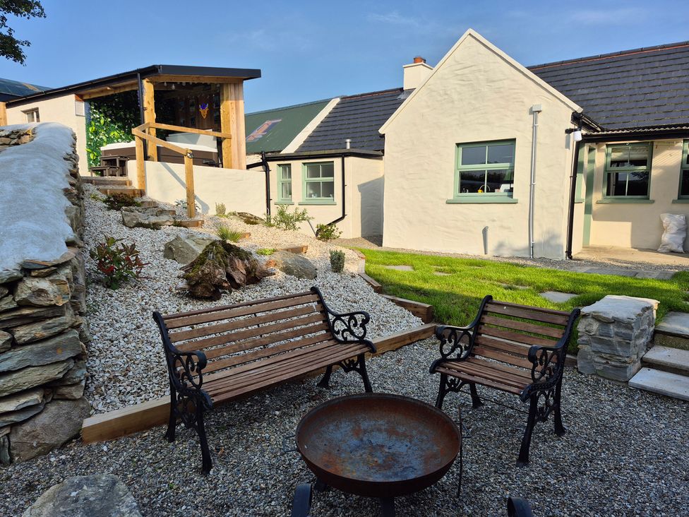 A garden with benches and a fire pit at Annie’s Farm Cottage Near Londonderry, Northern Ireland